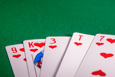 playing cards on the green table. Combination flush in poker