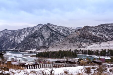 Landscape with snow-capped mountains and mountain riverの写真素材