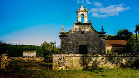 small medieval church built in granite stone that is part of a rural palace in Galiciaのeditorial素材