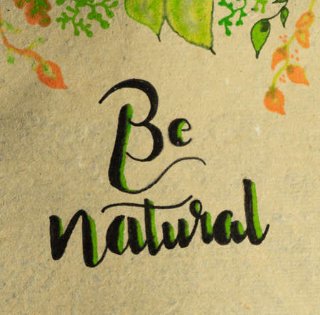 the words be naural estritas on a rough paper and with plant motifs at the topの写真素材