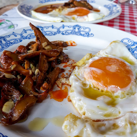 fried egg dishes to accompany some mushrooms cooked with garlicの写真素材