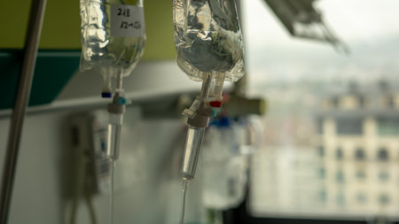 Intravenous treatment bags in a hospital discharge their vital contentsの写真素材