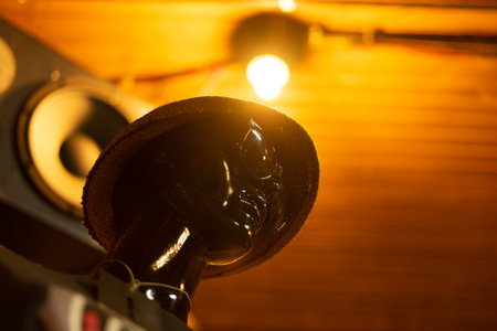 black mannequin whose head can only be seen with sunglasses and a hat under a speakerの写真素材