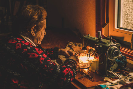 woman sews to machineの写真素材