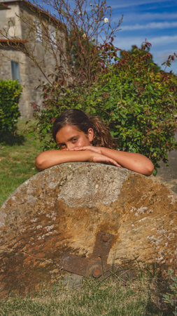 girl leaning on a stoneの写真素材
