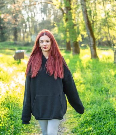 Redhead woman walking parkの写真素材
