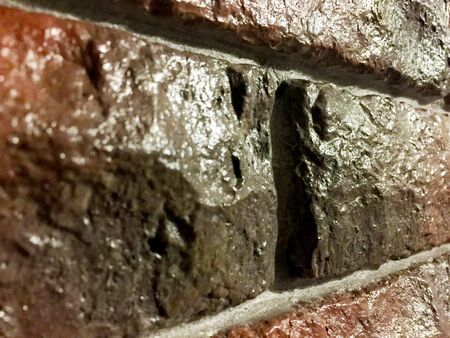 brick wall covered with glossy lacquer with embroidery interior old wallの写真素材