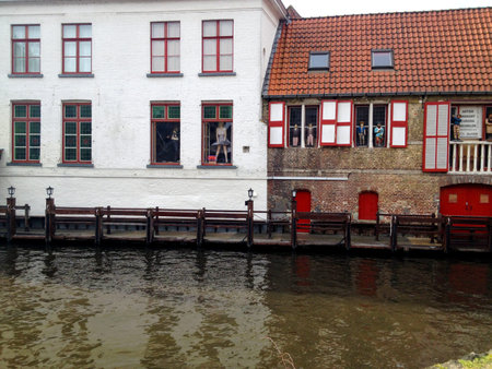 Shot of historic medieval buildings along a canal in Bruges, Belgiumの写真素材