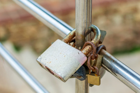 Various padlocks locked round pipes.の写真素材