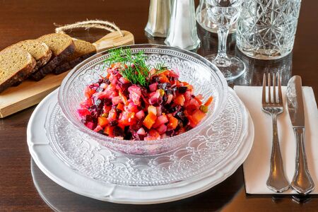 The vinaigrette of different various boiled vegetables, served in the restauranton the wooden table. Festive restaurant menu. の写真素材
