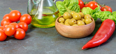 Dietary vegetables and healthy olive oil on the back background closeup. Healthy vegetables with vitamins and minerals.の写真素材