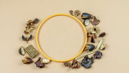 Dry vanilla flowers and petals round the frame on the honey dijon paper background. Nice greeting grange card with copy space.の写真素材