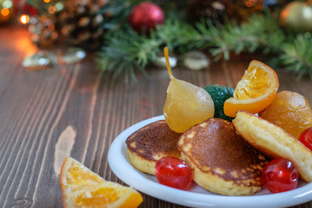 Japanese fluffy pancakes with spanish glazed fruits on the white plate, on the home wooden Christmas...