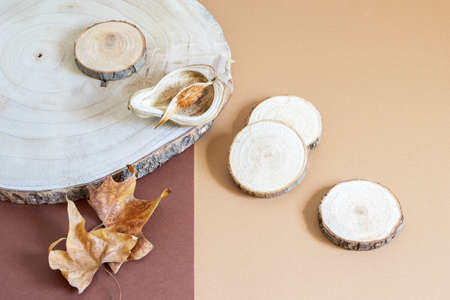 Wooden decorative boards and natural dry leaves on the brown paper background. Autumn textured elements.Top view, copy space.の写真素材