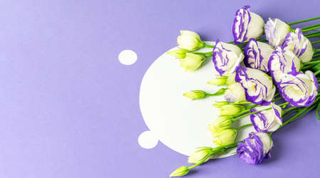 Bouquet of blue and white lisianthus. Blue background with white blank for invitation or greeting text with Mother's day, Womens day or Valentine's day. Top view, banner photo.の写真素材
