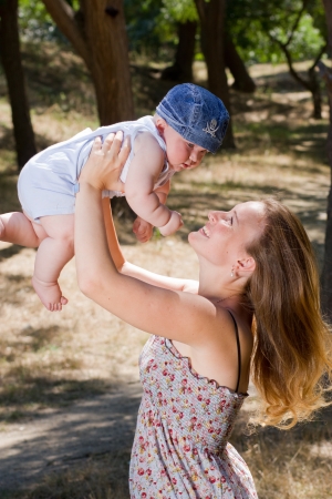Mother playing with baby in the parkの写真素材