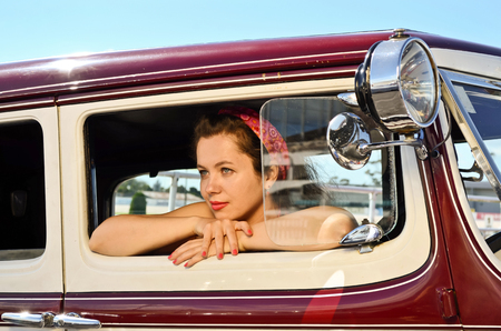 Young woman at vintage car and fashion show in Auckland, New Zealandの写真素材
