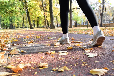 Jogging in the park during fall seasonの写真素材