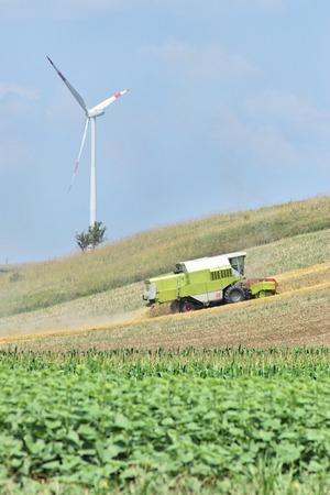 Combine harvester working in the farmland in springの写真素材