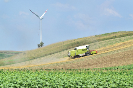 Combine harvester working in the farmland in springの写真素材