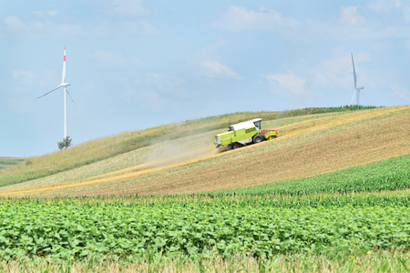 Combine harvester working in the farmland in springの写真素材