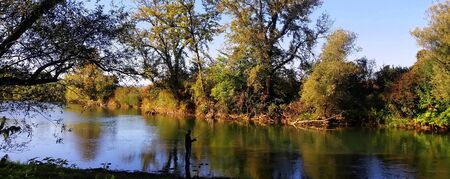 Silhouette of a fisherman in the river Krka, Sloveniaの写真素材