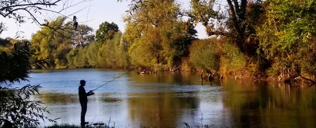 Silhouette of a fisherman in the river Krka, Sloveniaの写真素材