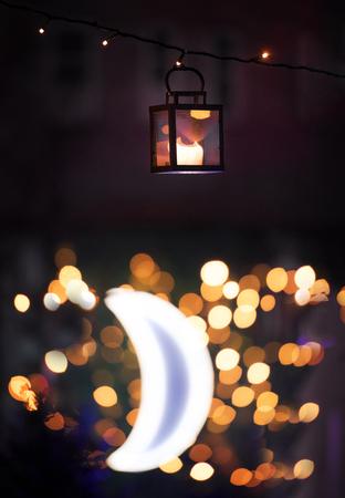 Lantern at night with moon in the backgroundの写真素材