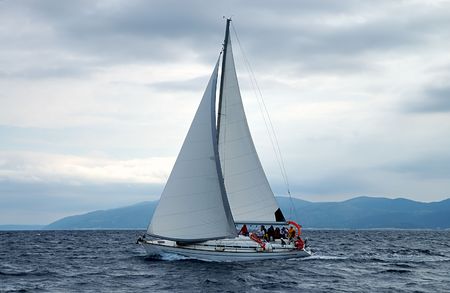 Sailing under cloudy sky before the stormの写真素材