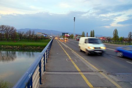 Late afternoon traffic - cars passing by over bridgeの写真素材