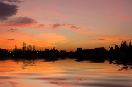 Skyscape with city silhouette at dawnの写真素材