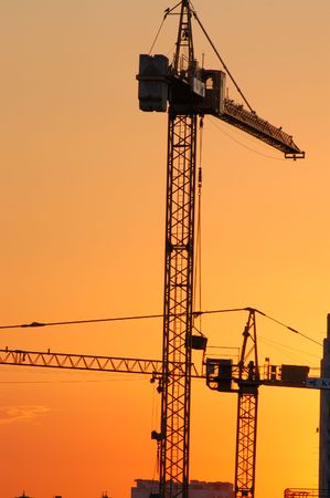 Construction site - cranes at dawn (vertical version)の写真素材