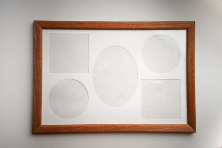 Wooden frame for several photos on white isolate.Empty spaces for inserting photos.