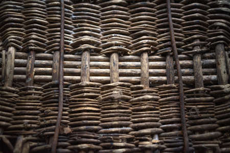 The texture of the weaving of the old basket is gray. Braided background for text.の写真素材