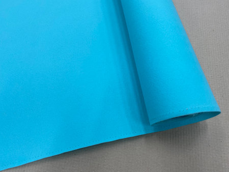 A sheet of blue felt fabric on the table.の写真素材