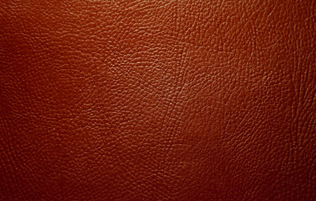 Photo of the texture of genuine leather in red.The leather background of the luxury brand.
