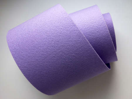 A piece of purple felt fabric on a white background. sale of fabric.の写真素材