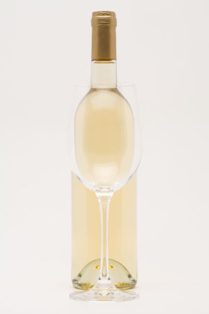 white wine bottle with empty glass in frontの写真素材