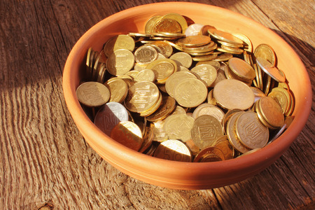 coins on brown baclground of woodenの写真素材