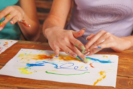 Art and creativity concept. Young beautiful women painting with fingers. の写真素材