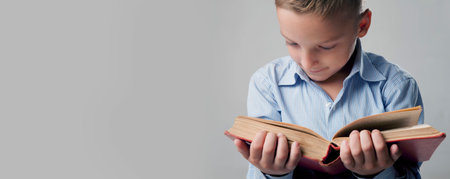Little boy reading book as symbol of motivation to success and self development.