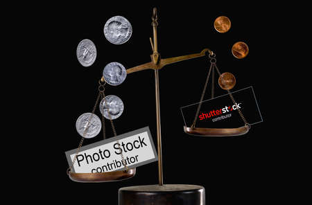 Editorial conceptual image: A few cents per photo with the Shutterstock contributor inscription as symbol of depreciation of the work of photographers.のeditorial素材