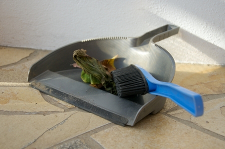 shovel and broom on the tiled floorの写真素材