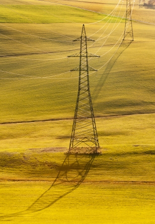electrical tower over an autumnal rural hill landの写真素材