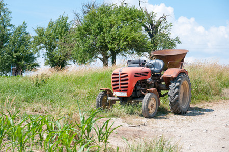 ancient tractor on a fieldの写真素材
