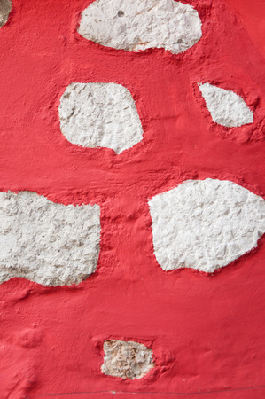 red and white painted ancient house wall background textureの写真素材