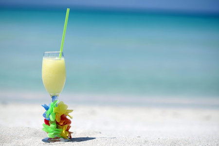 Pina Colada cocktail on Caribbean beach with copy space