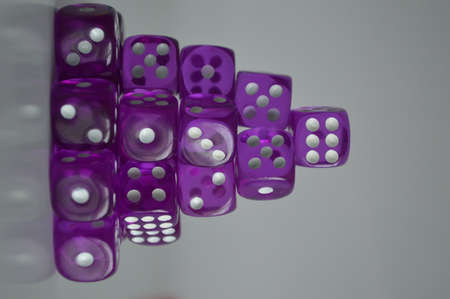 pile of multiple purple plastic arcylic d6 six sided die dice variable focusの写真素材