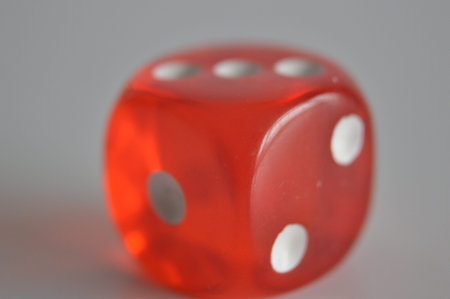 red plastic arcylic d6 six sided die dice close up variable focusの写真素材