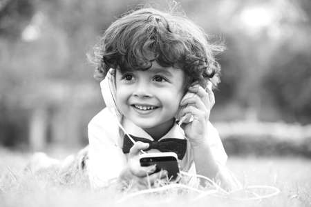 little boy listening music in headphones stock imageの写真素材